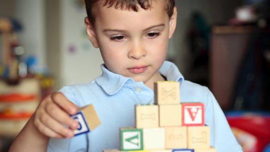 Autistic boy building blocks