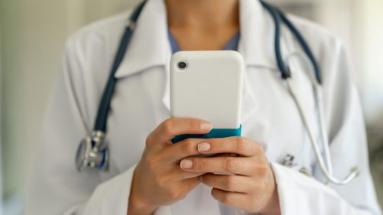 Clinician texting on phone