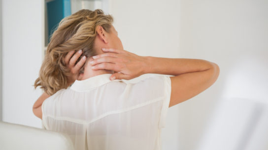woman massaging her painful neck