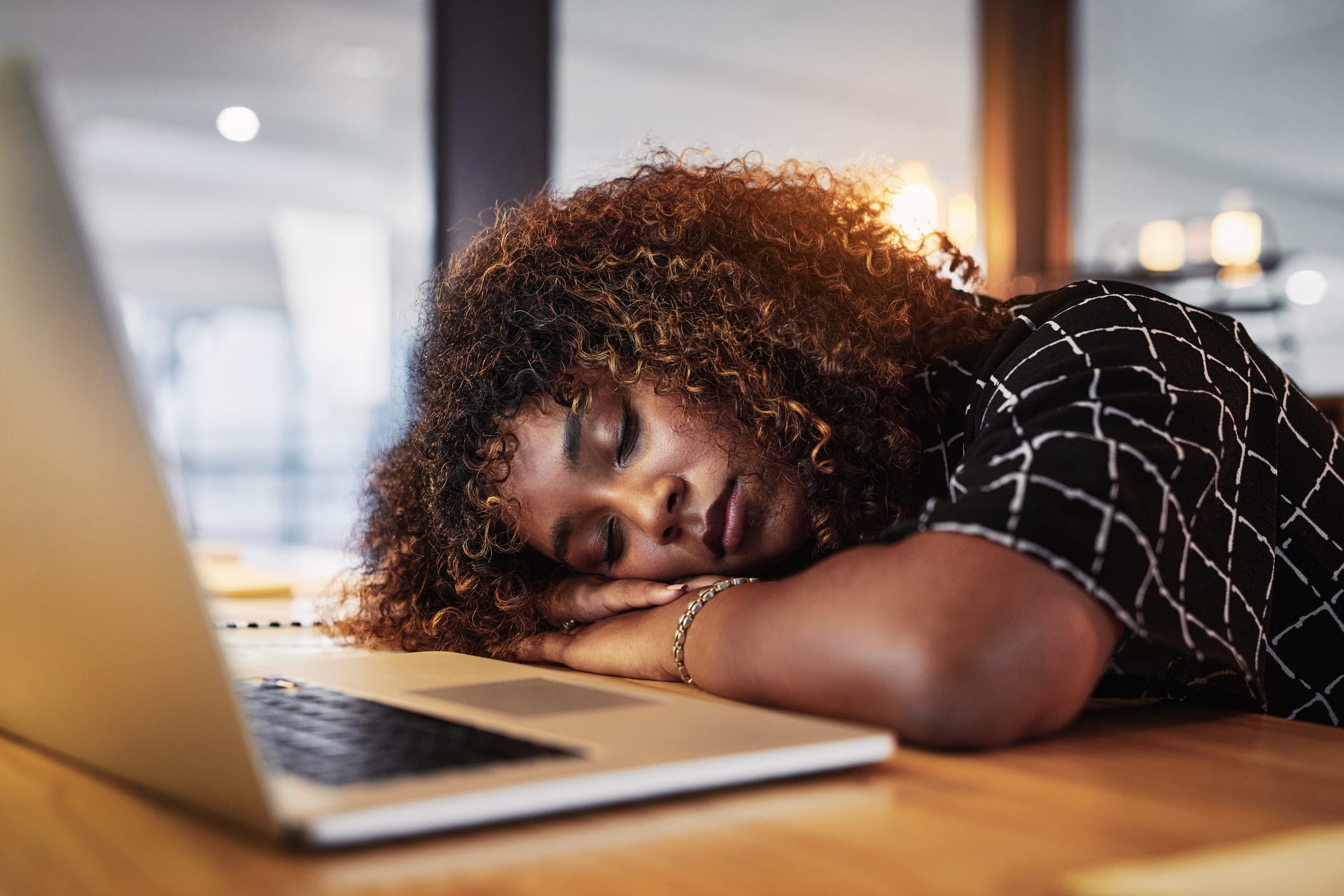 young woman sleeping at desk