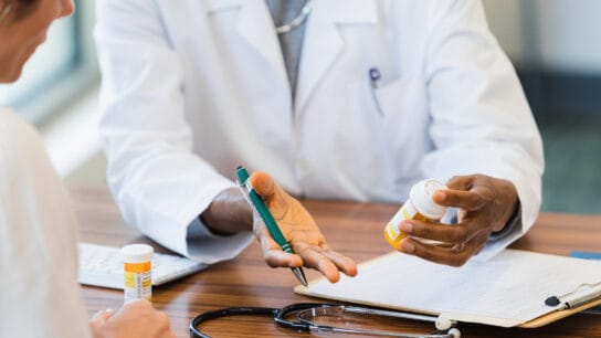 Female doctor discusses medication with patient