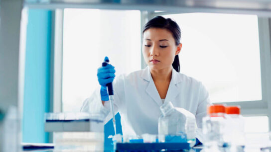 Female-scientist-using-pipette-in-modern-research-laboratory