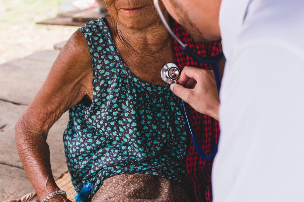 Male-Doctor-listening- heart-beat-and-breathing-of-Elderly-Woman