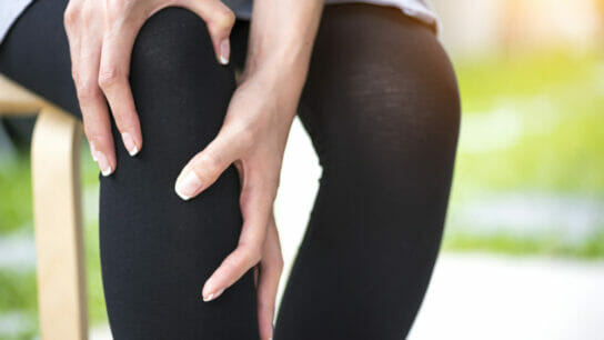 an-individual-pressing-hands-against-pain-in-knee