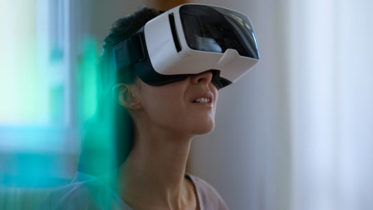 Woman wearing virtual reality goggles.