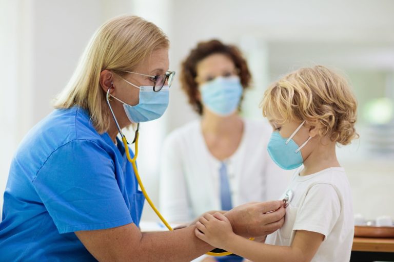 pediatrician examining pediatric patient