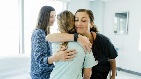 pediatrician embracing child patient, pediatrics