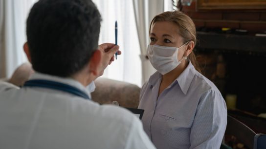 Doctor examining a patient's sight during a house call