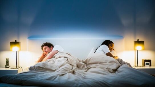 sleepless-couple-laying-on-opposite-sides-of-a-bed
