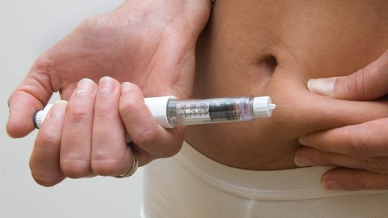 patient injecting herself in the stomach